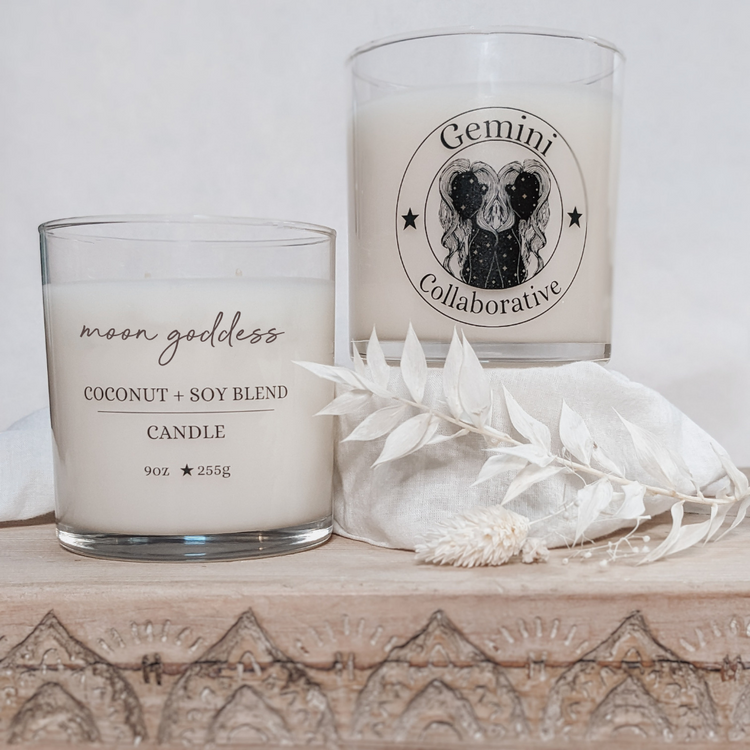 Photo of two candles side by side with dried florals in the background.
