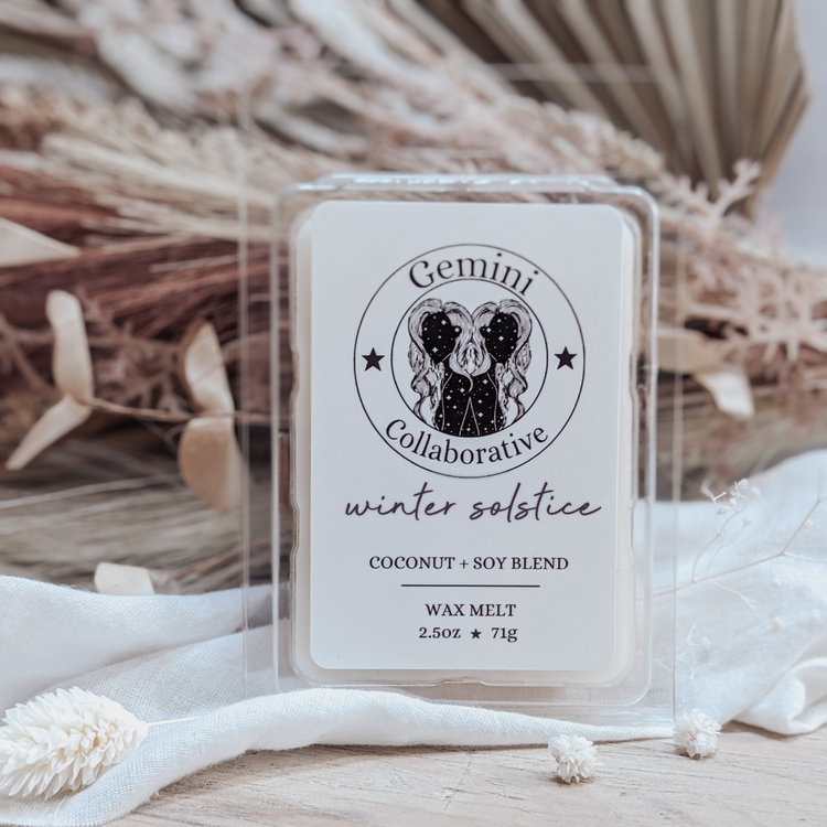 Photo of wax melts inside plastic clamshell with dried florals in the background.