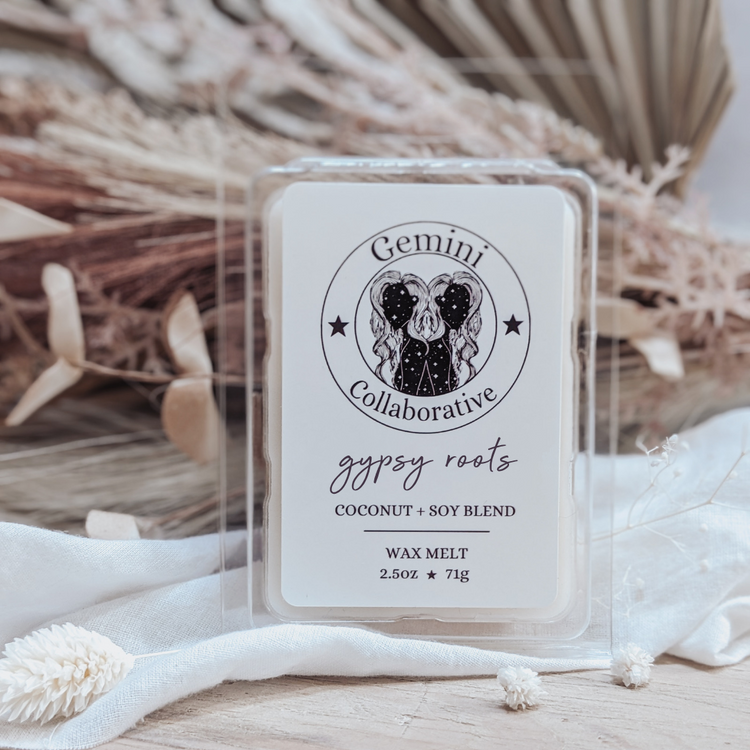 Photo of wax melts inside plastic clamshell with dried florals in the background.