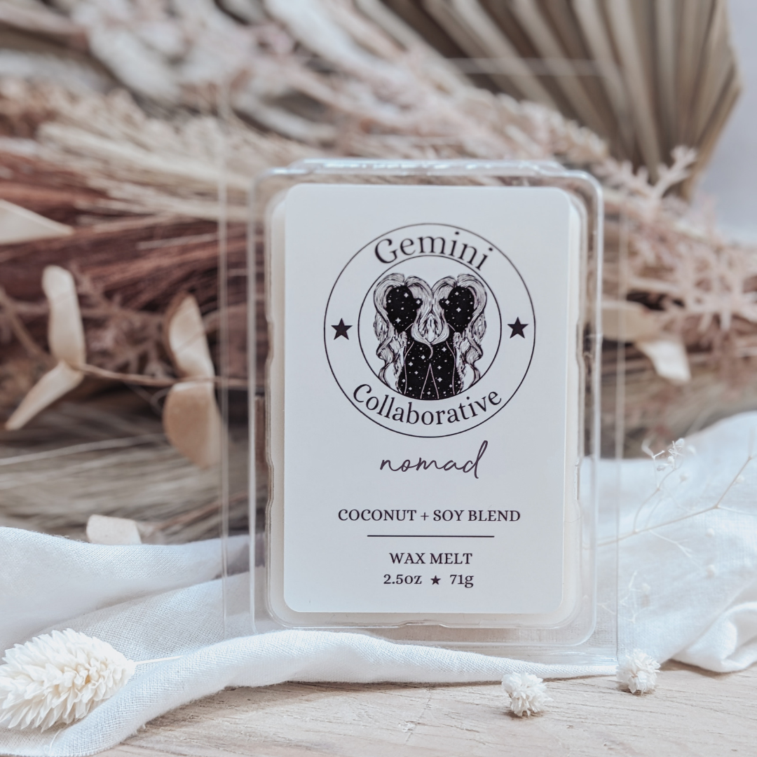 Photo of wax melts inside plastic clamshell with dried florals in the background.