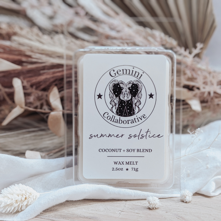 Photo of wax melts inside plastic clamshell with dried florals in the background.